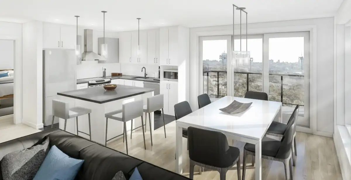 Salon-cuisine d'un condo locatif Luxenbourg : aire ouverte, îlot de cuisine, table à dîner et grandes fenêtres donnant sur la ville